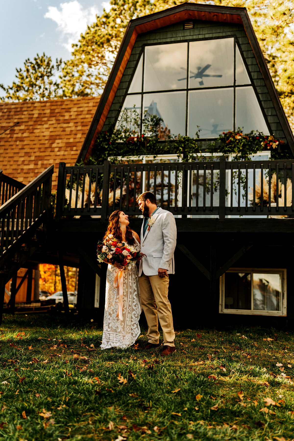 married couple celebrating in front of Atlas Aframe in Minnesota