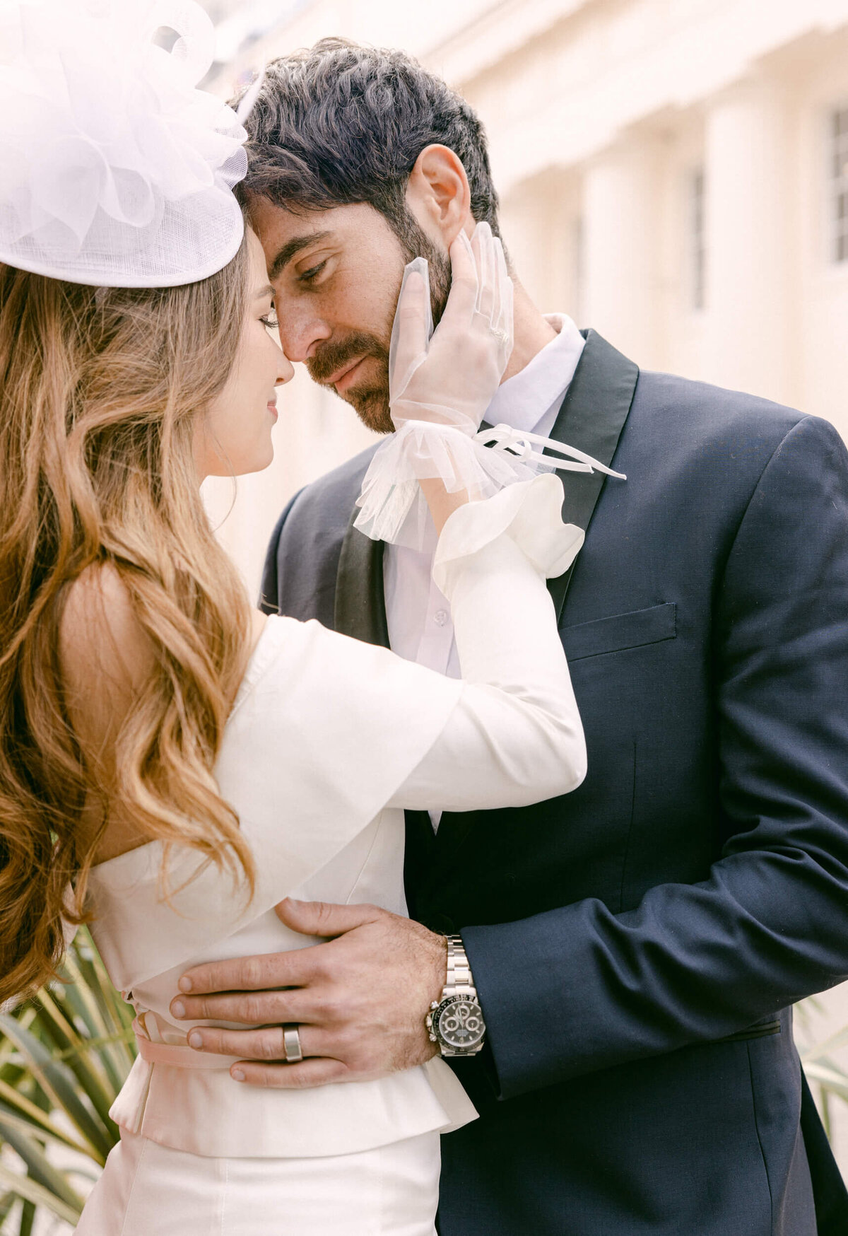A wedding day photo of the couple walking down a cobble street in London in the United Kingdom