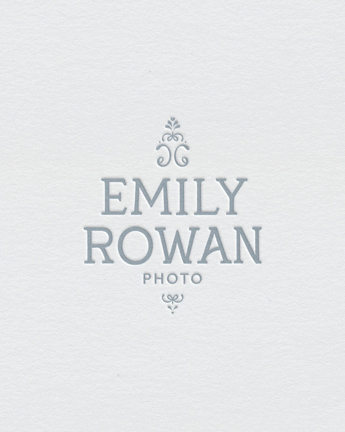 Elegant serif logo in soft blue, designed for a fine art wedding photographer seeking a luxury, high-end brand identity.