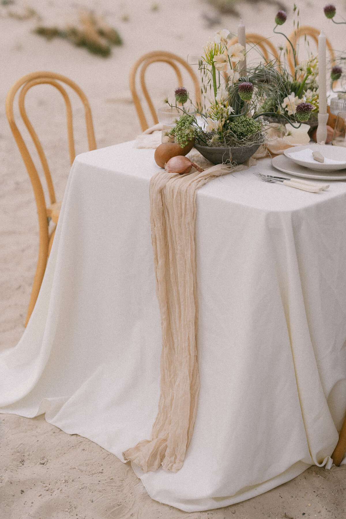 Long table sitting on a beach for a wedding reception in Oregon