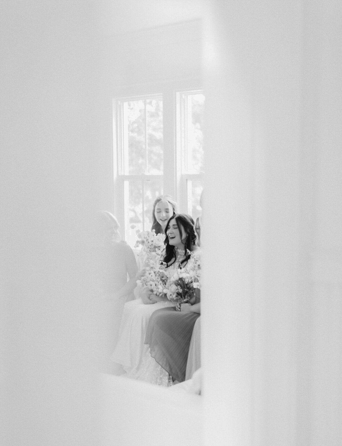 creative documentary film wedding photographer in Michigan, Christina Harrison captures bridesmaids laughing