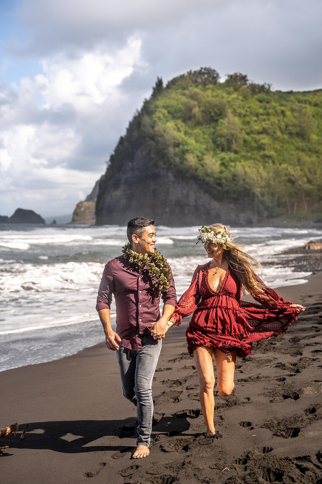 Couple running across beach for Hawaii engagement photos by Hawaii Adventure Portraits