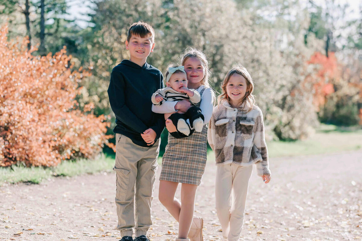 The 4 kids standing on a path together. 