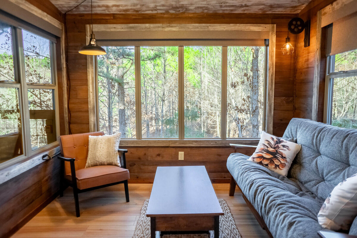 Inviting sunroom with pull out futon bed inside Wolf Pen Gap cabin