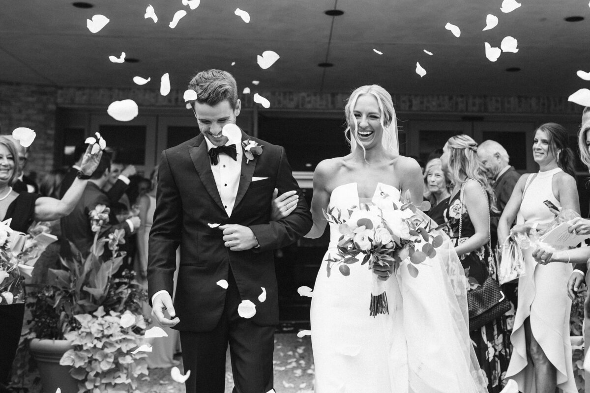 Bride and Groom leaving church from flower petals
