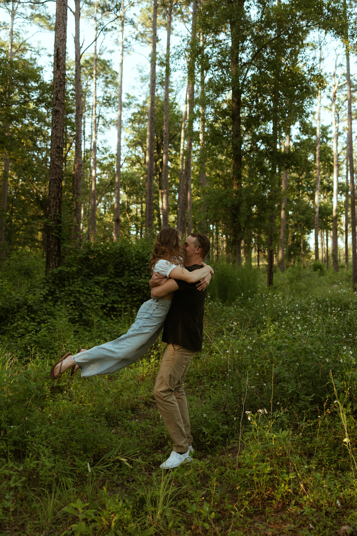 Couple posing for portraits in a forest.