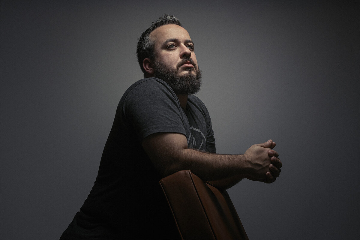 A man leaning on the back of a chair