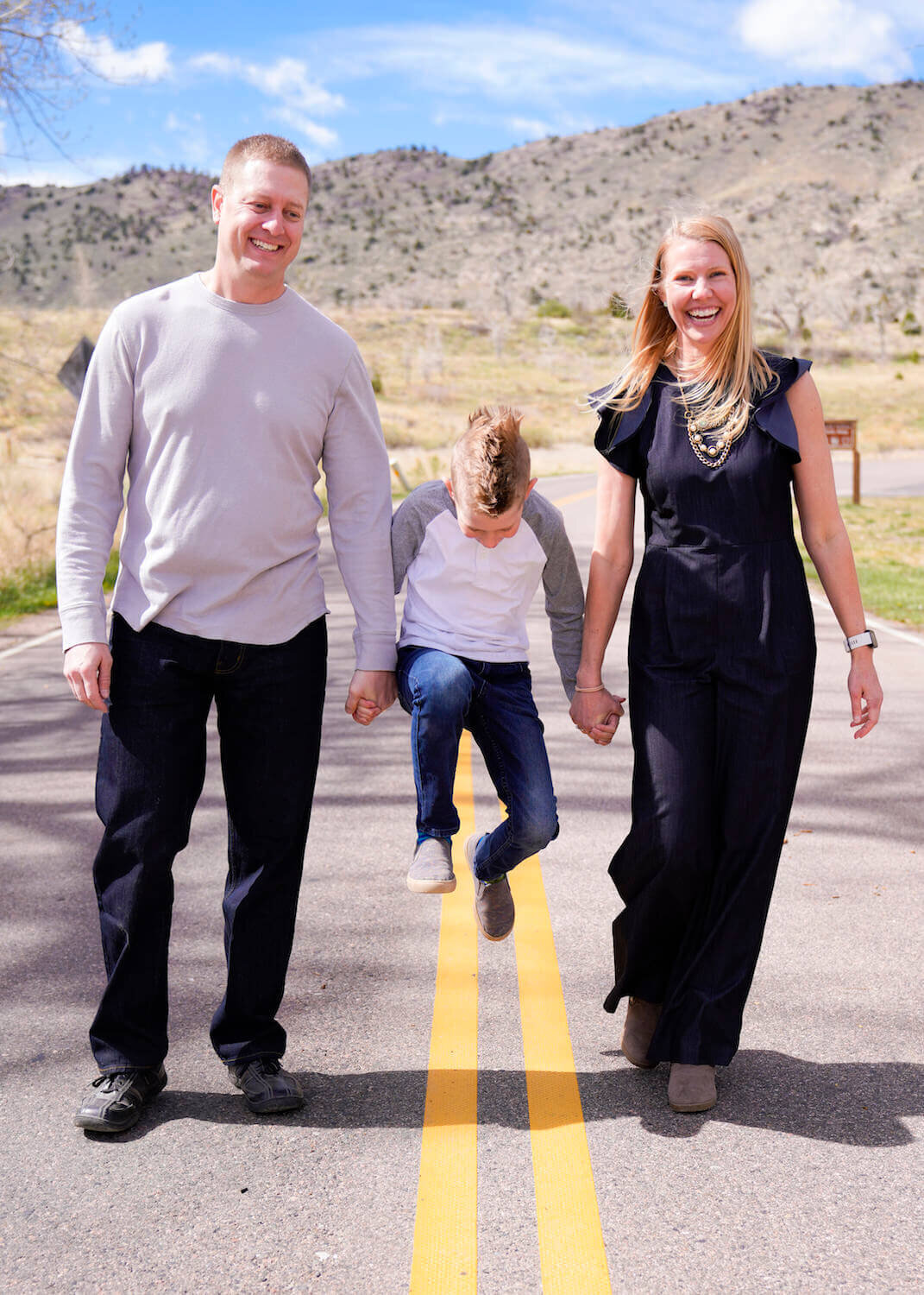 denver family photography - parents and son standing in road