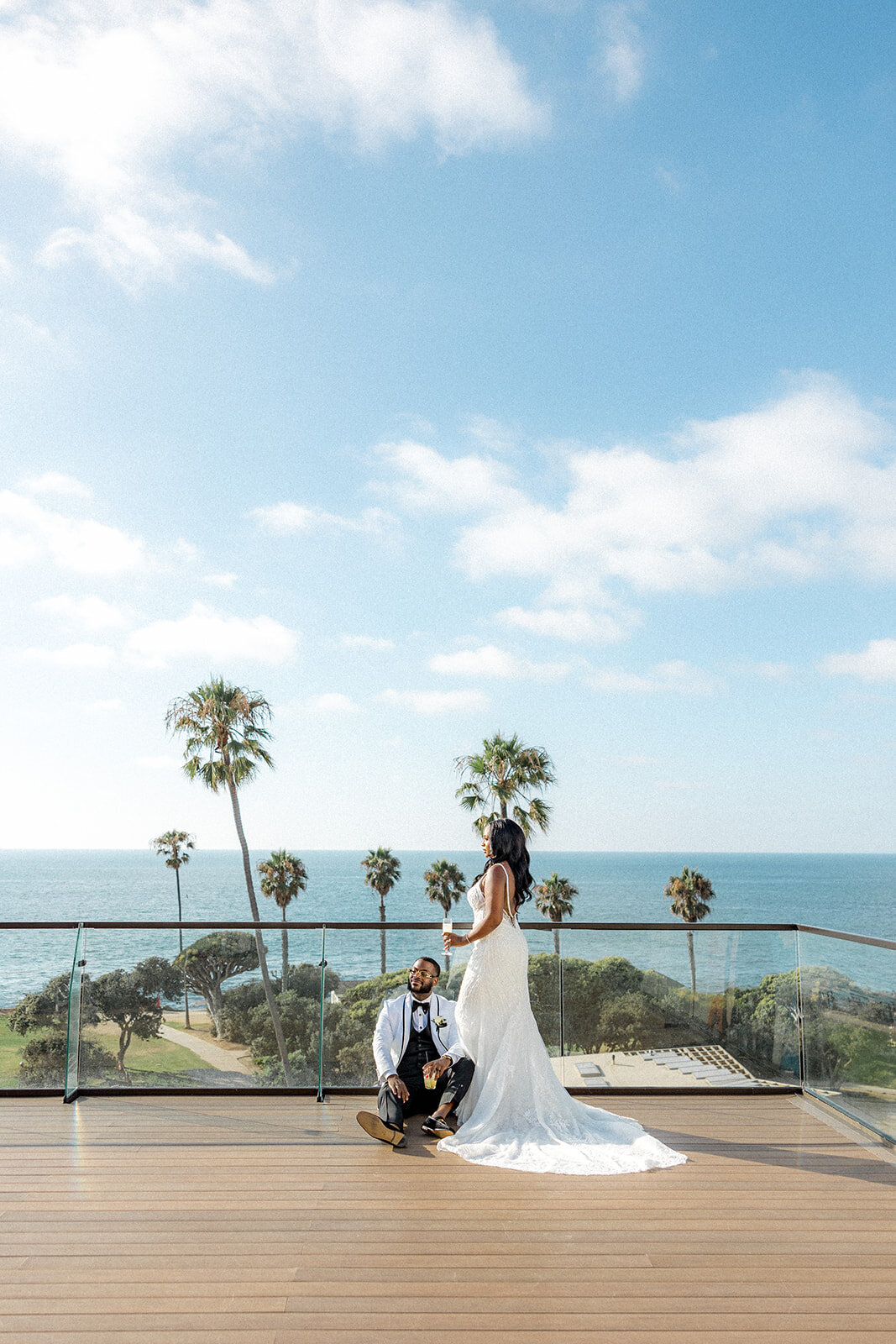 Bride and groom smiling in San Diego with ocean in the back