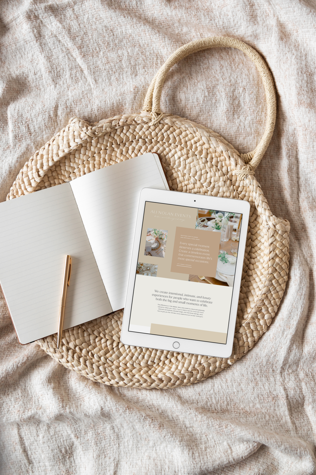 Ipad showcasing website page mockup against a open notebook with a golden pen resting by its side.