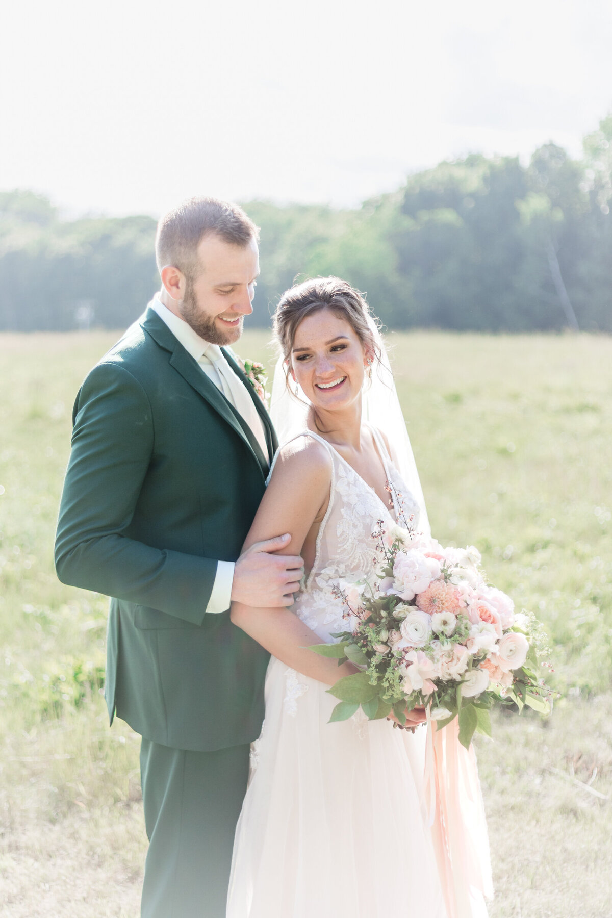 A portrait of a married couple in a field