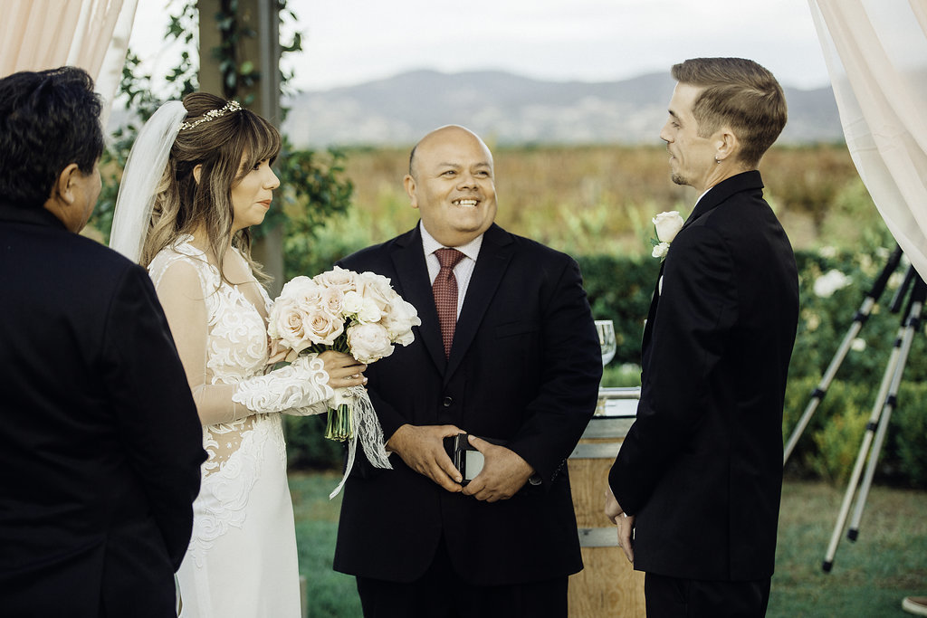 Wedding Photograph Of Two Men in Black Suit And Bride Smiling Los Angeles