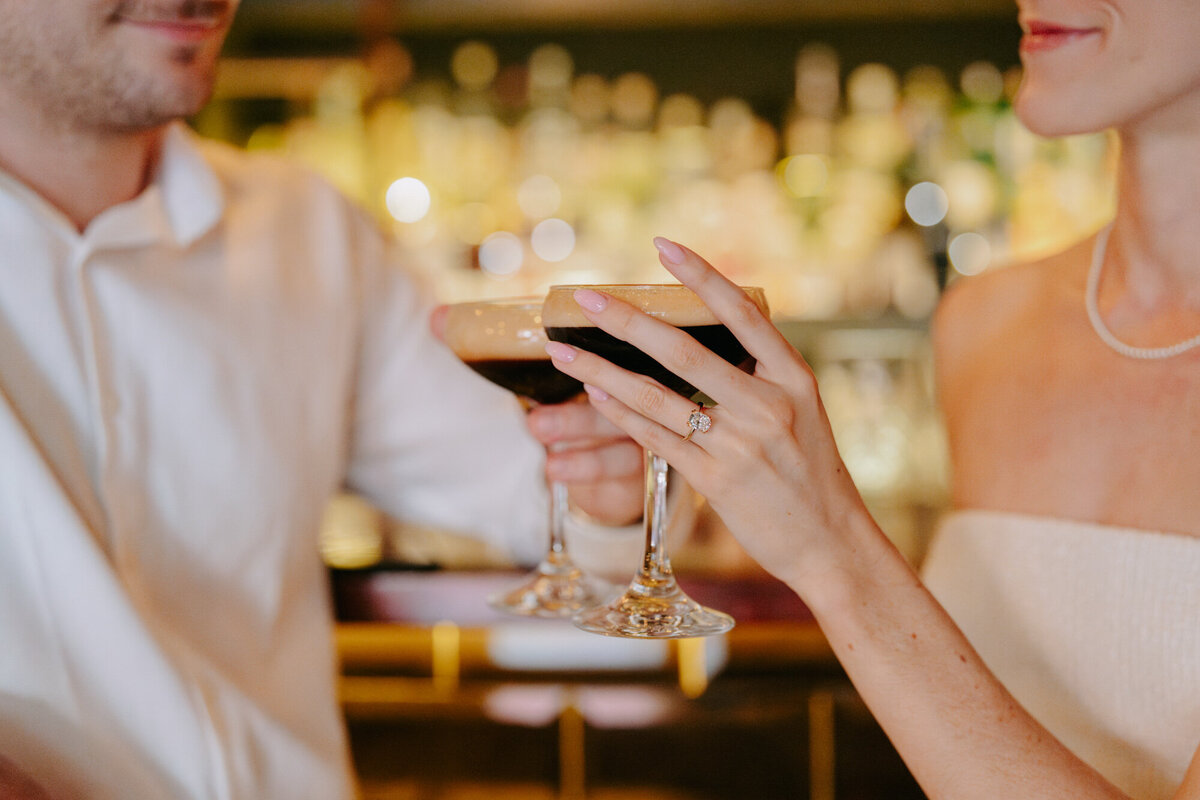engaged couple drinking espresso martinis in bar