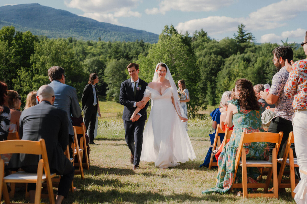Bride and groom recess down aisle after wedding ceremony at the Bark Eater Inn in Keene NY
