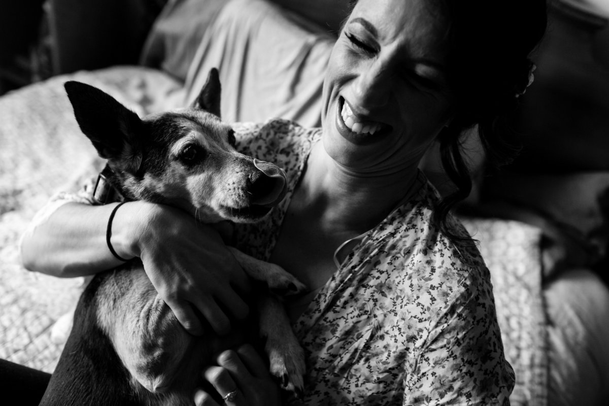 The bride gets a kiss from her dog on her wedding day in Newmarket New Hampshire