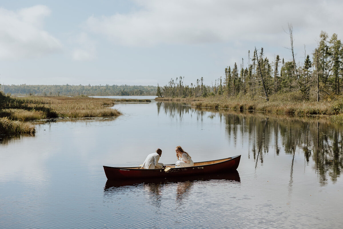 bride and groom canoeing in a lagoon on Lake Superior on Madeline Island
