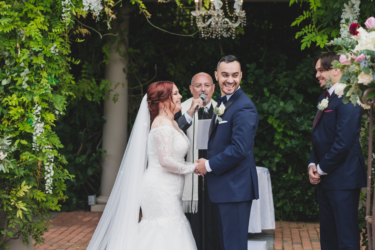 bride and groom during ceremony smiling at crest hollow country club