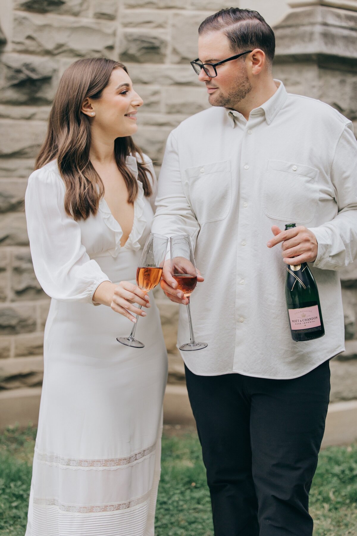 Engaged couple popping champaign at their engagement session by NovaMarkina Photography