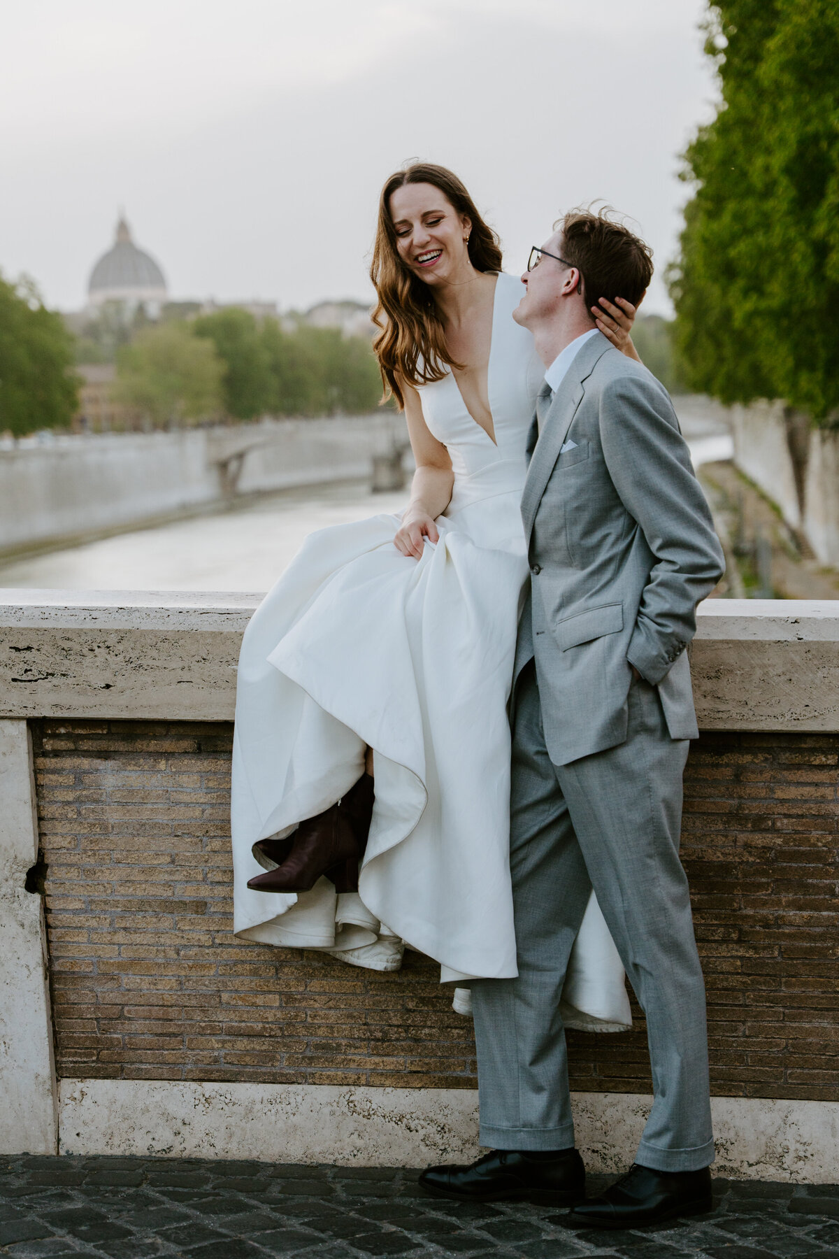 Bride and groom in cozy Roman alley looking at each other.