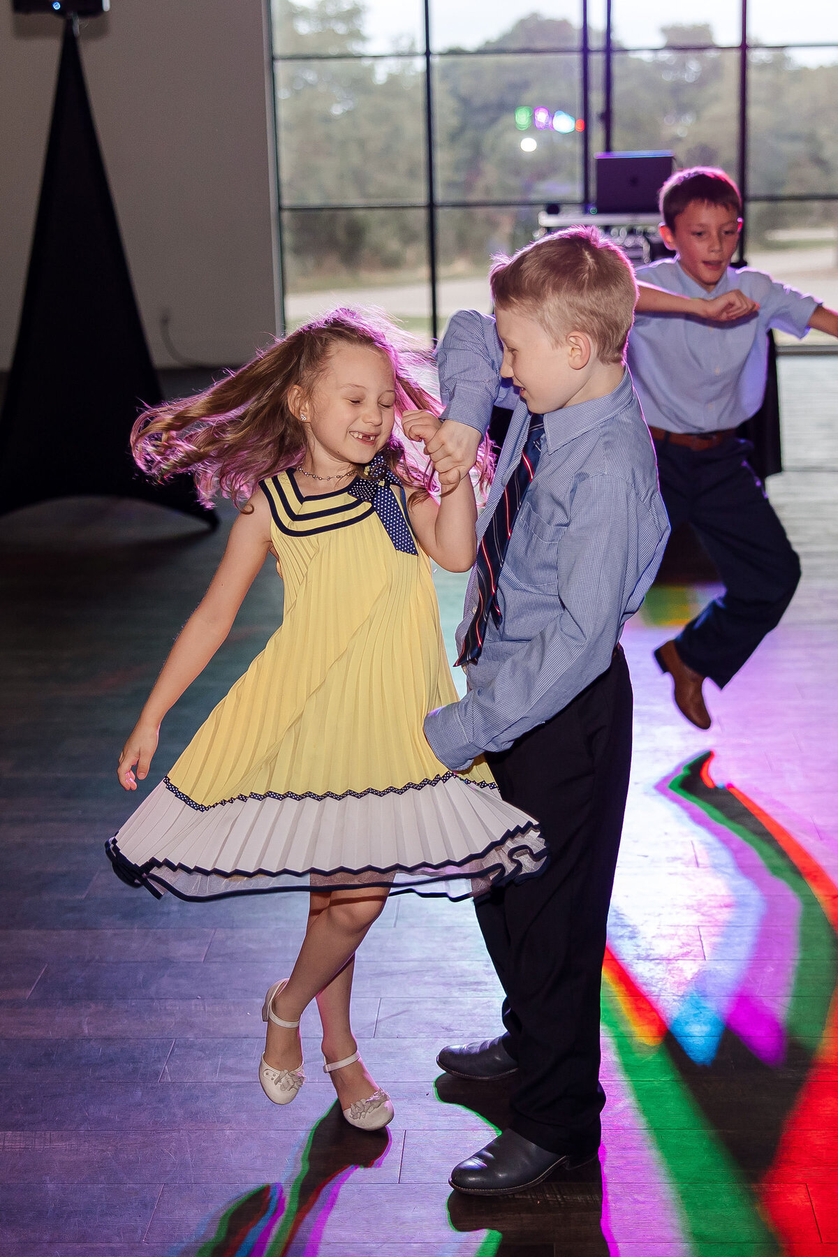 children dance at wedding reception little girl in yellow dress
