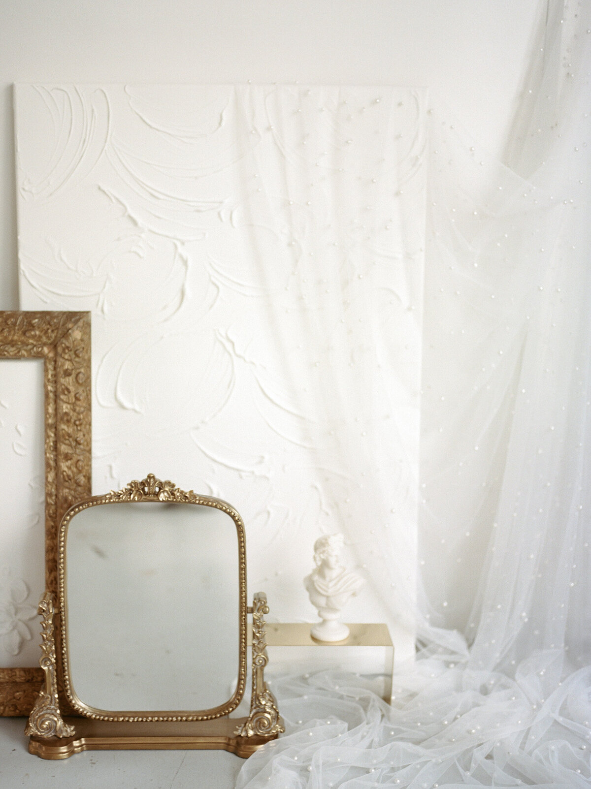 gold anthropologie mirror, textured backgrounds, sculptural bust candle, florist brand photos details