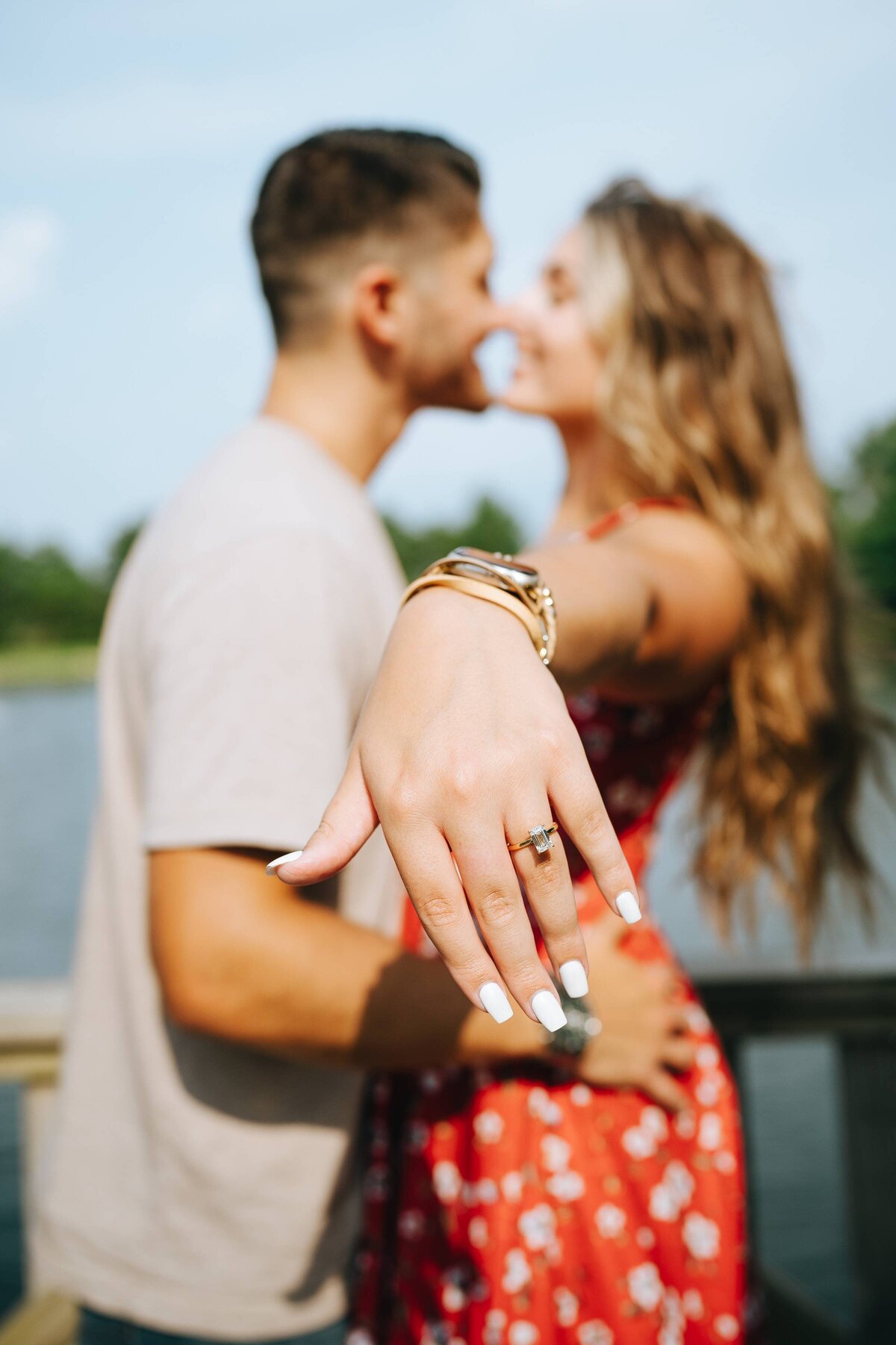 couple-kissing-showing-ring
