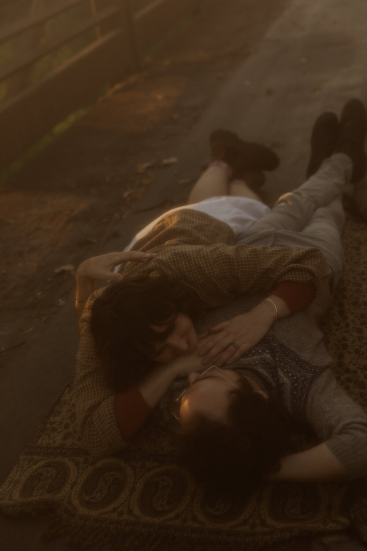 Film Like Couples Photo of a Couple Laying on a Blanket 