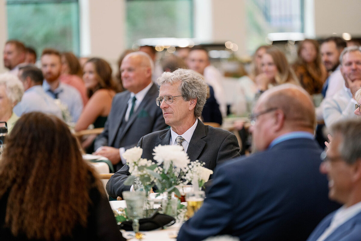 Candid moment of guests celebrating at the reception inside Leona Road Wedding Venue in Grand Rapids MI.
