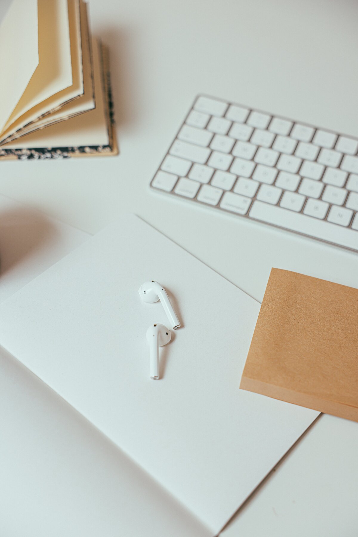 Airpods on Elle's desk - Organizational Change Coach in Denver, Co - Elle Banks Coaching