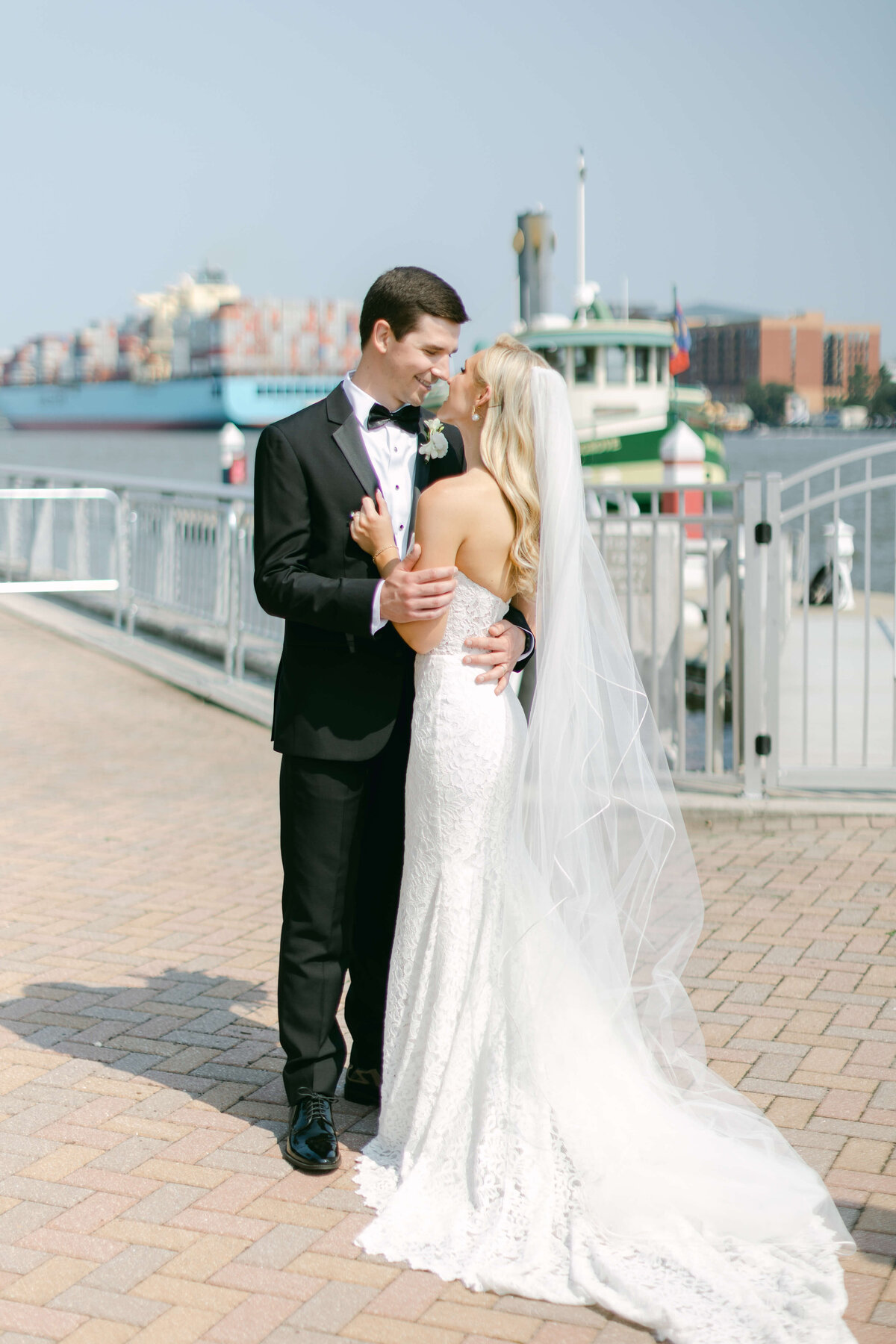 A bride and groom hold eachother in front of Savannah.