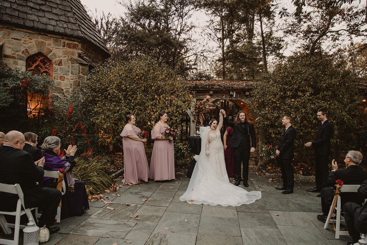 Newlyweds celebrating as they finish their wedding ceremony 