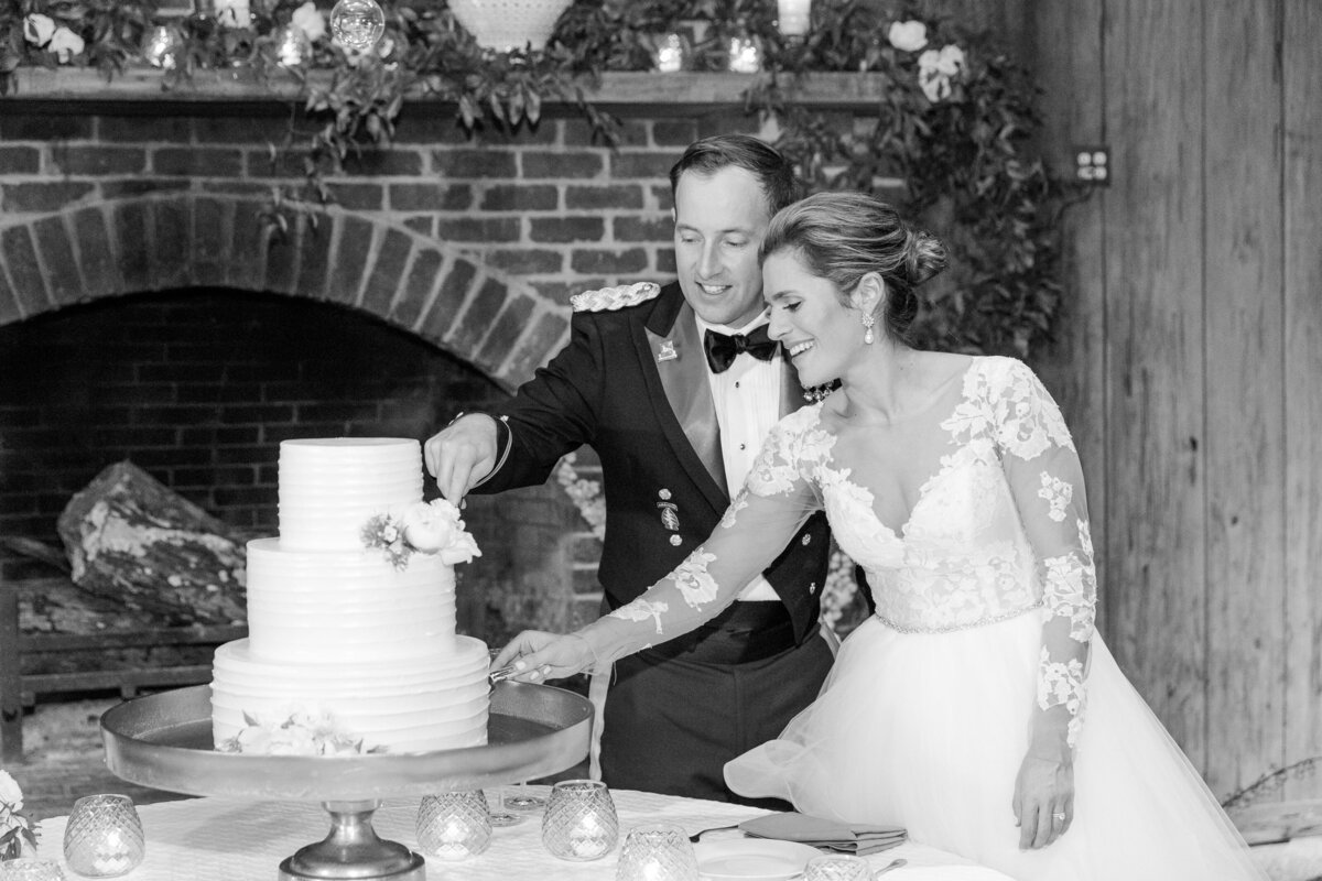Bride and groom cut the cake at their  Boone Hall Plantation elegant spring soiree wedding  |  Charleston wedding photographer Dana Cubbage Weddings