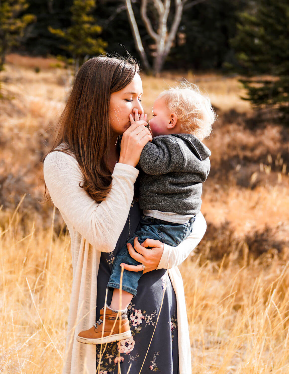 denver family photography - woman holding son and kissing hand