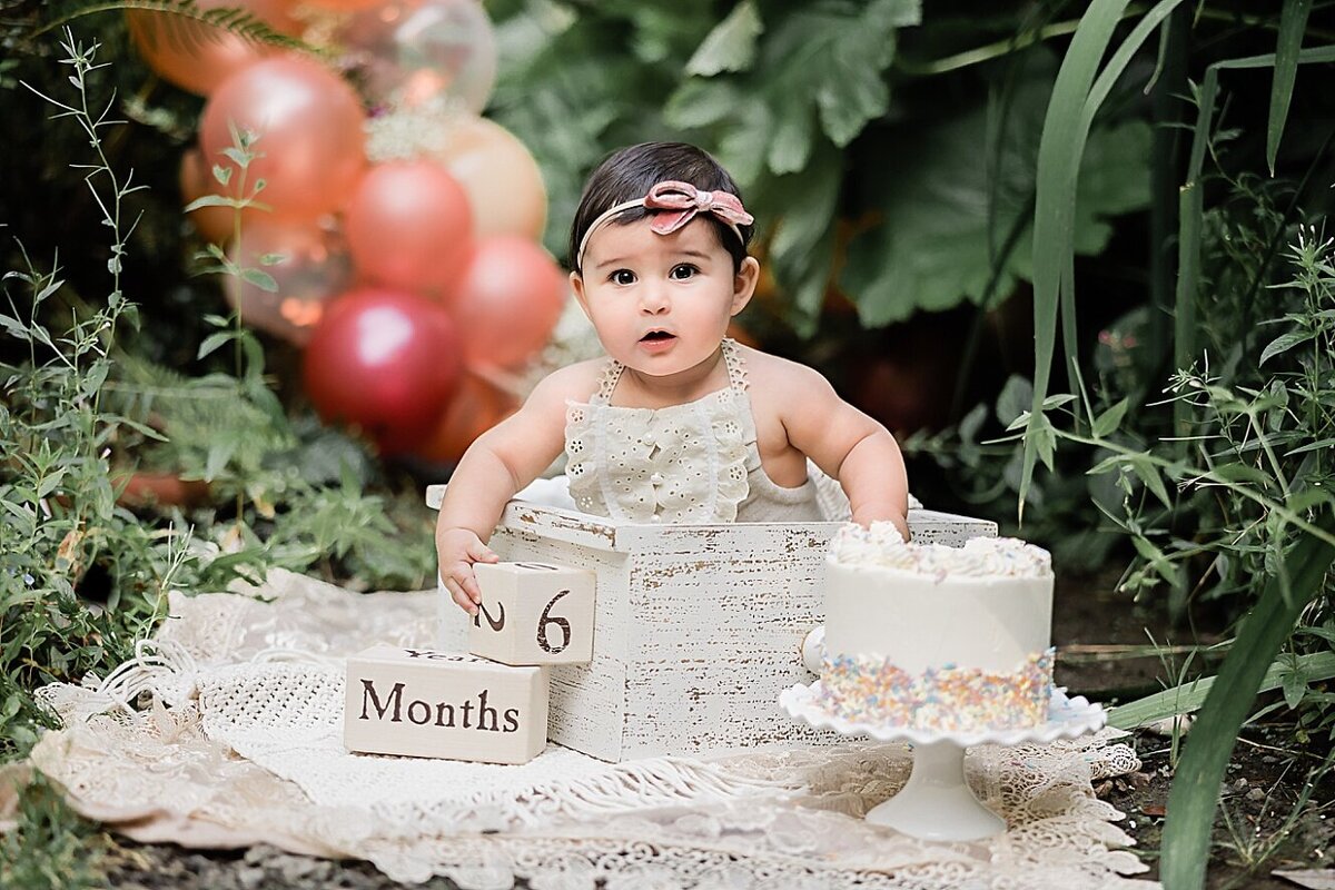 half birthday baby pictures with cake and balloons in beaverton oregon