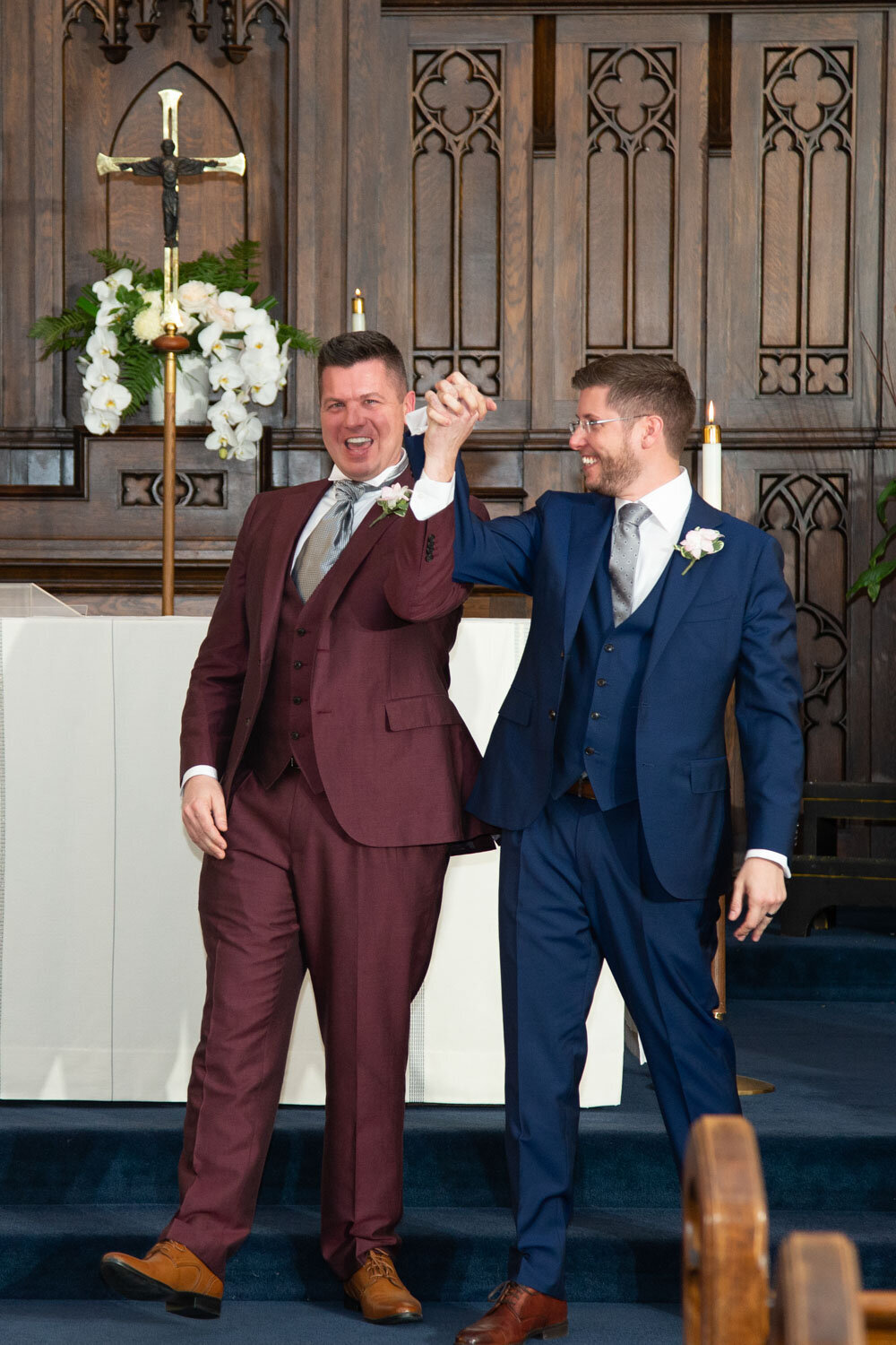 Two men in suits are standing next to each other