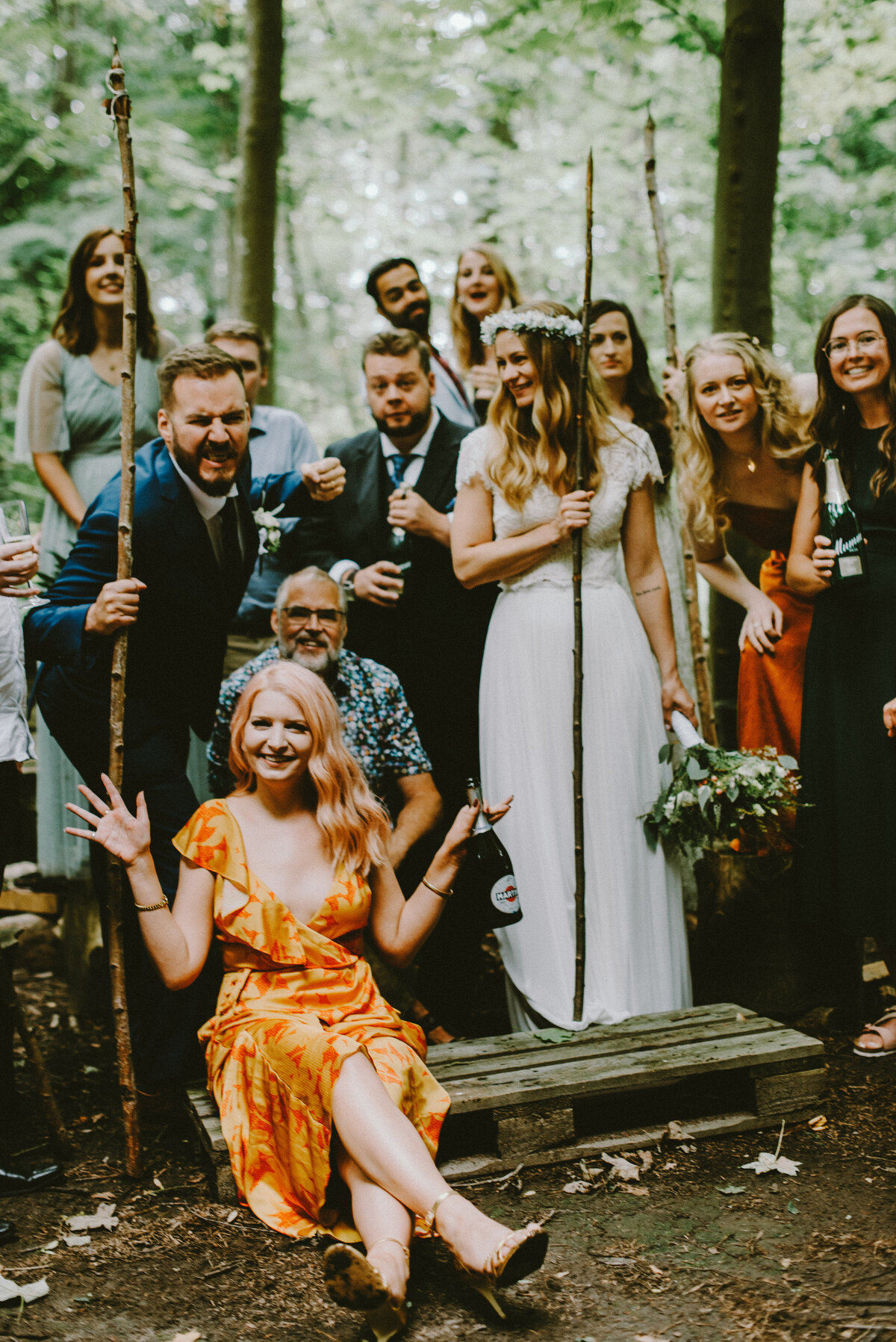 Wedding guests posing in the forest as they have destination wedding abroad in Denmark