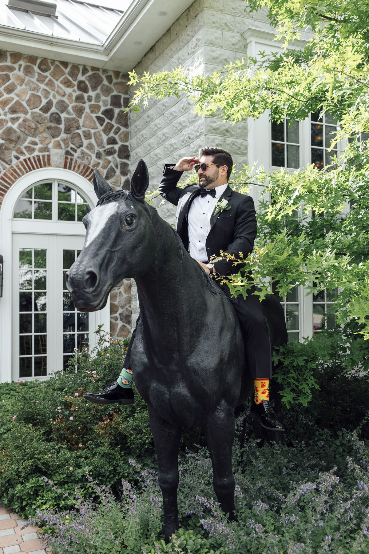 ryland-inn-summer-wedding-photo-groom-riding-horse-statue-whitehouse-station-new-jersey