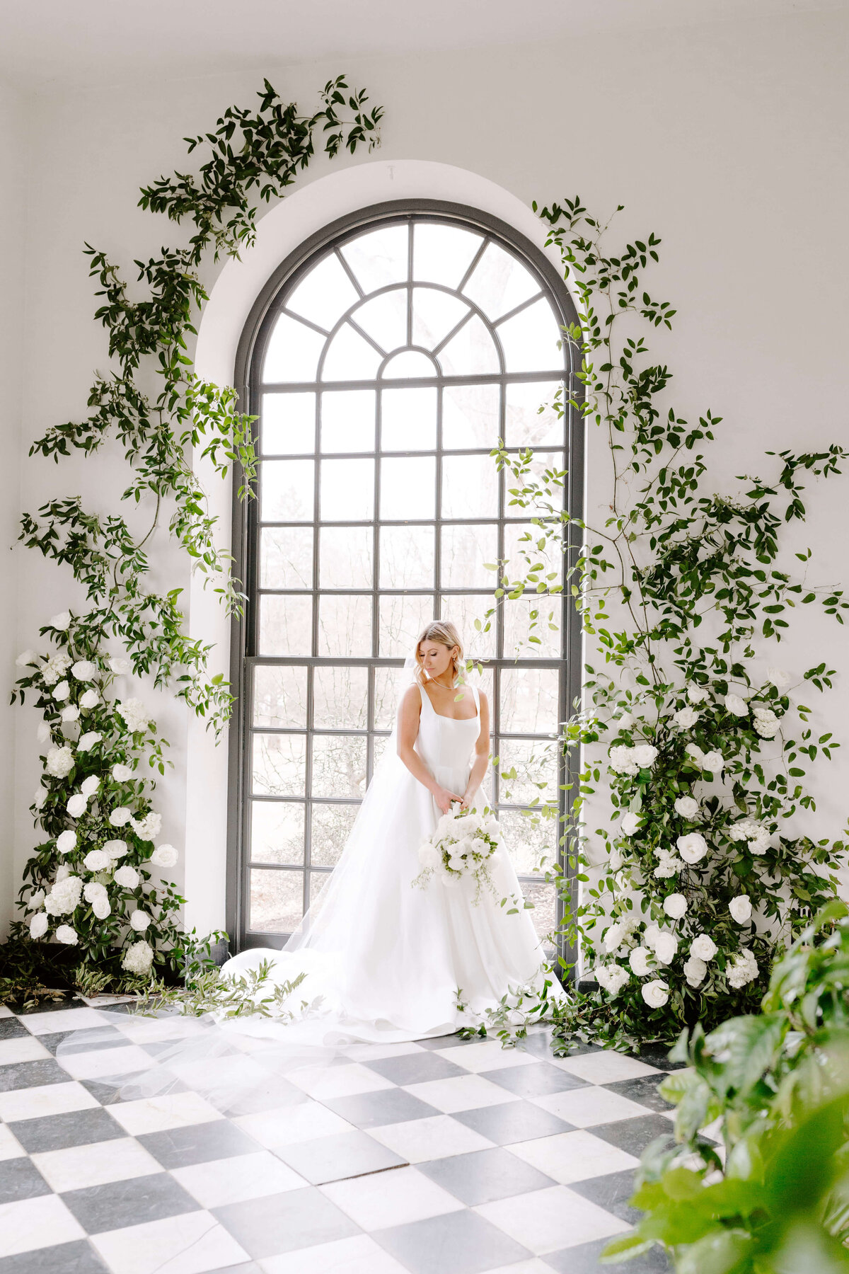 bride in front of large oval window at conestoga house and gardens wedding