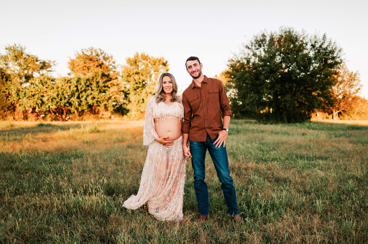 pregnant couple holding hands during Springfield MO maternity photography session