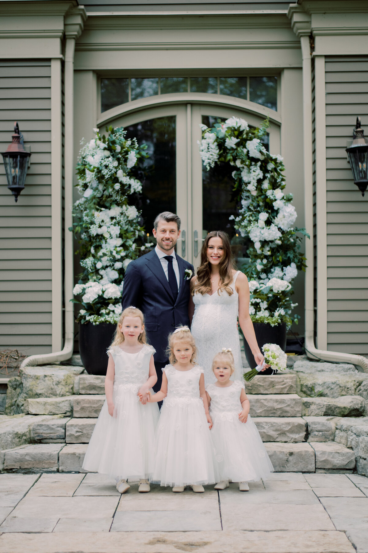 Bride and Groom share a moment with three flower girls in oakville ON