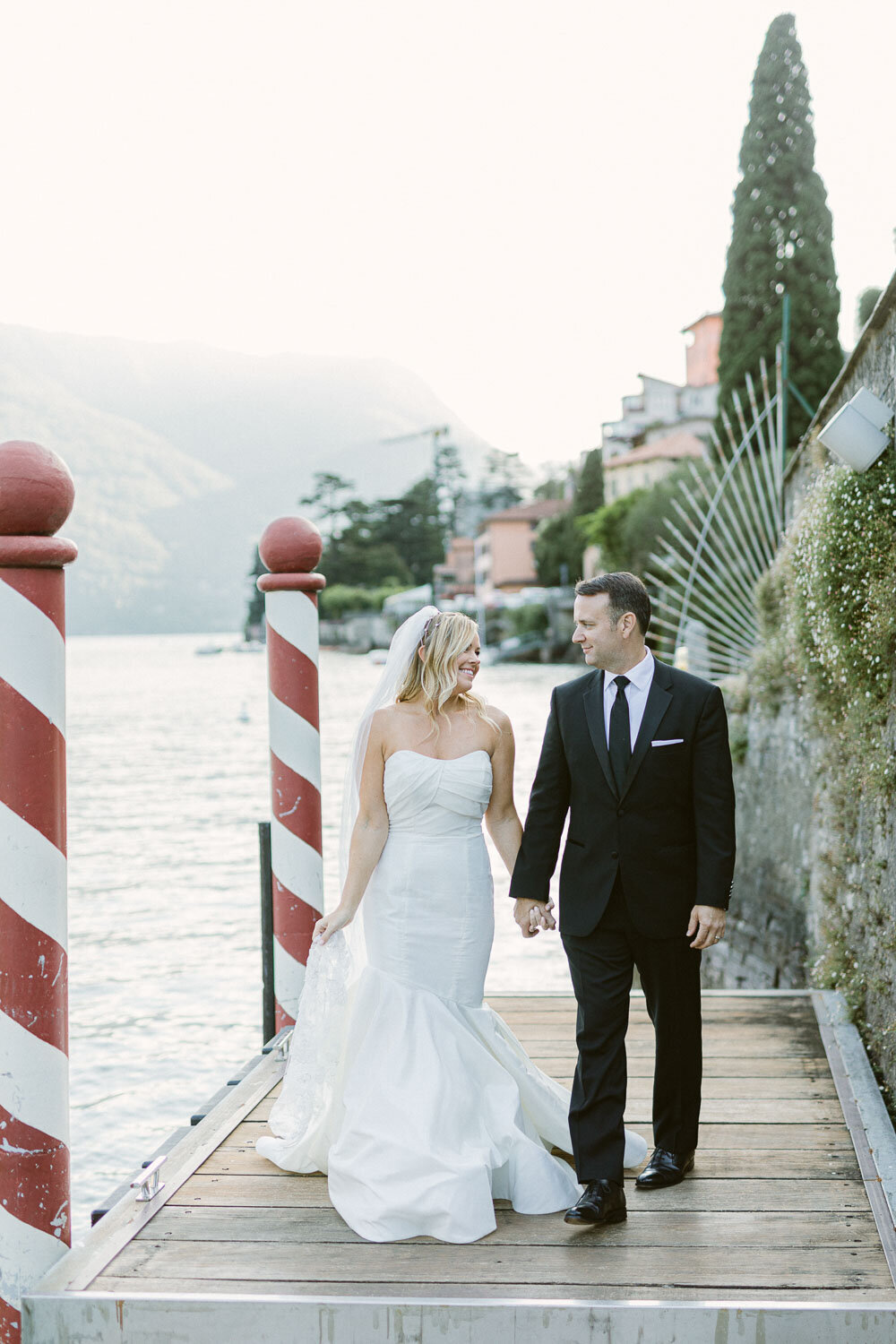 bride and groom on the deck at lake como