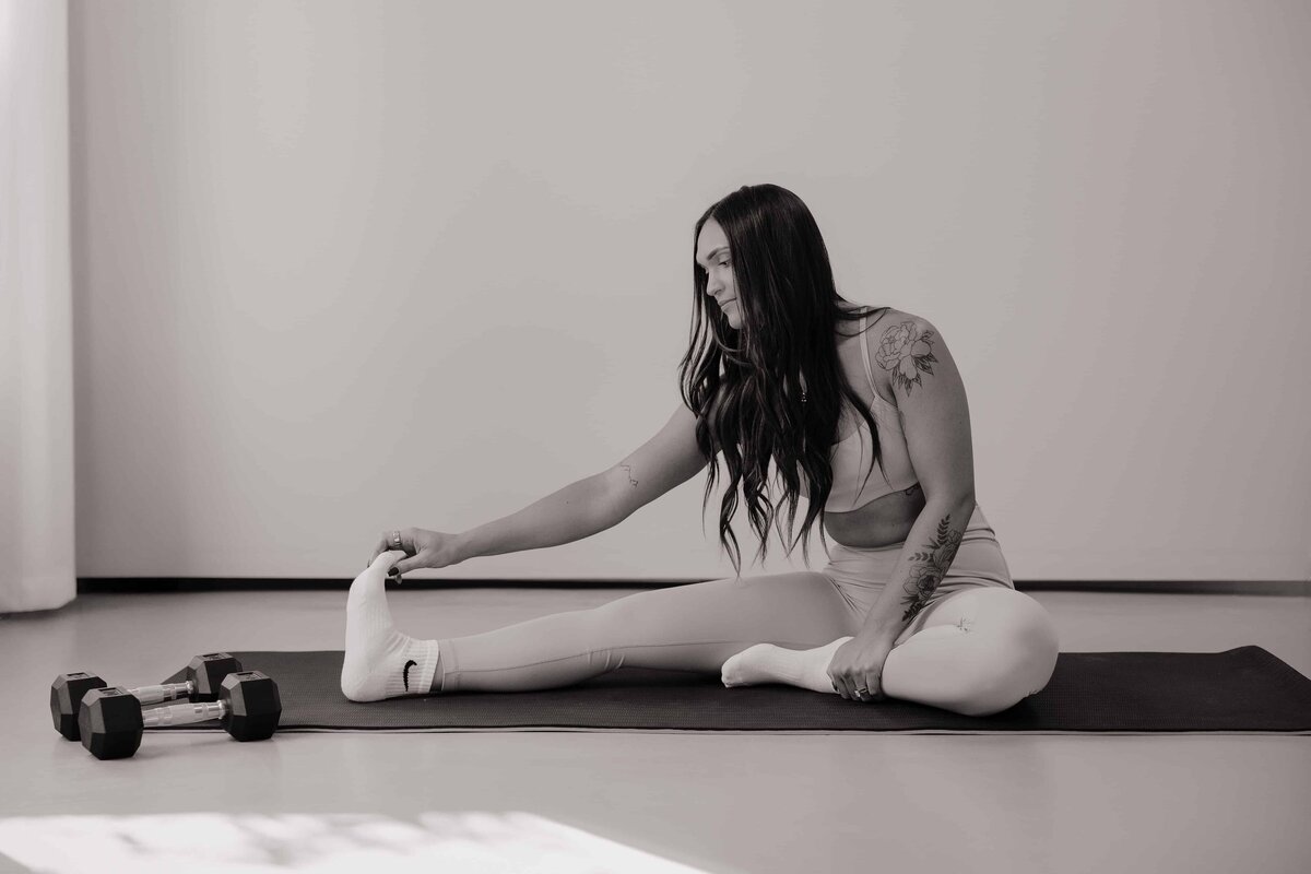 A woman stretches during her branding session in Northern Colorado.