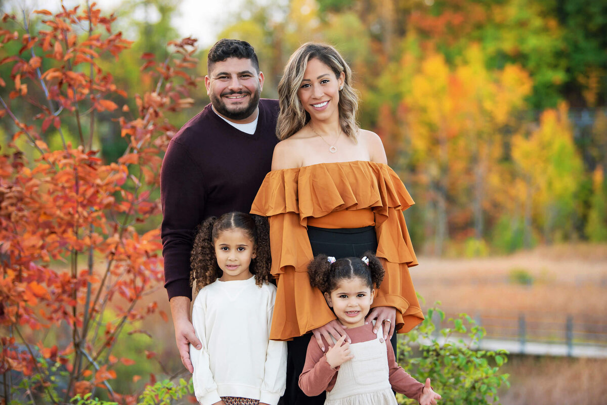 up-close photo of mom and dad with their two daughters for their fall family photos in Burlington, ON