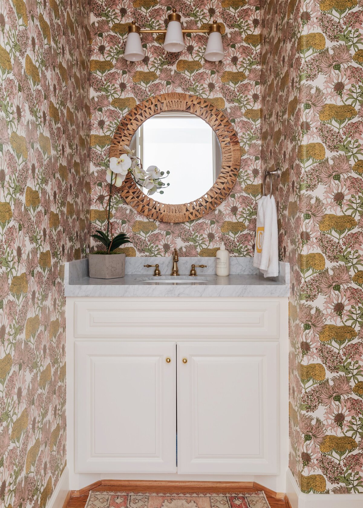 oyster creek studios oak forest remodel  brown floral wallpaper and white vanity in bathroom