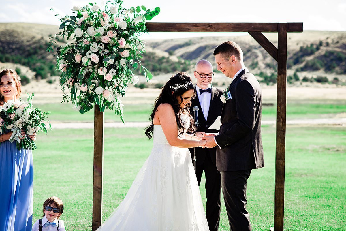 Couple exchanging rings during their ceremony at Headwaters Ranch