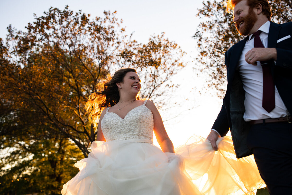 Newlyweds run and celebrate during golden hour wedding day portraits