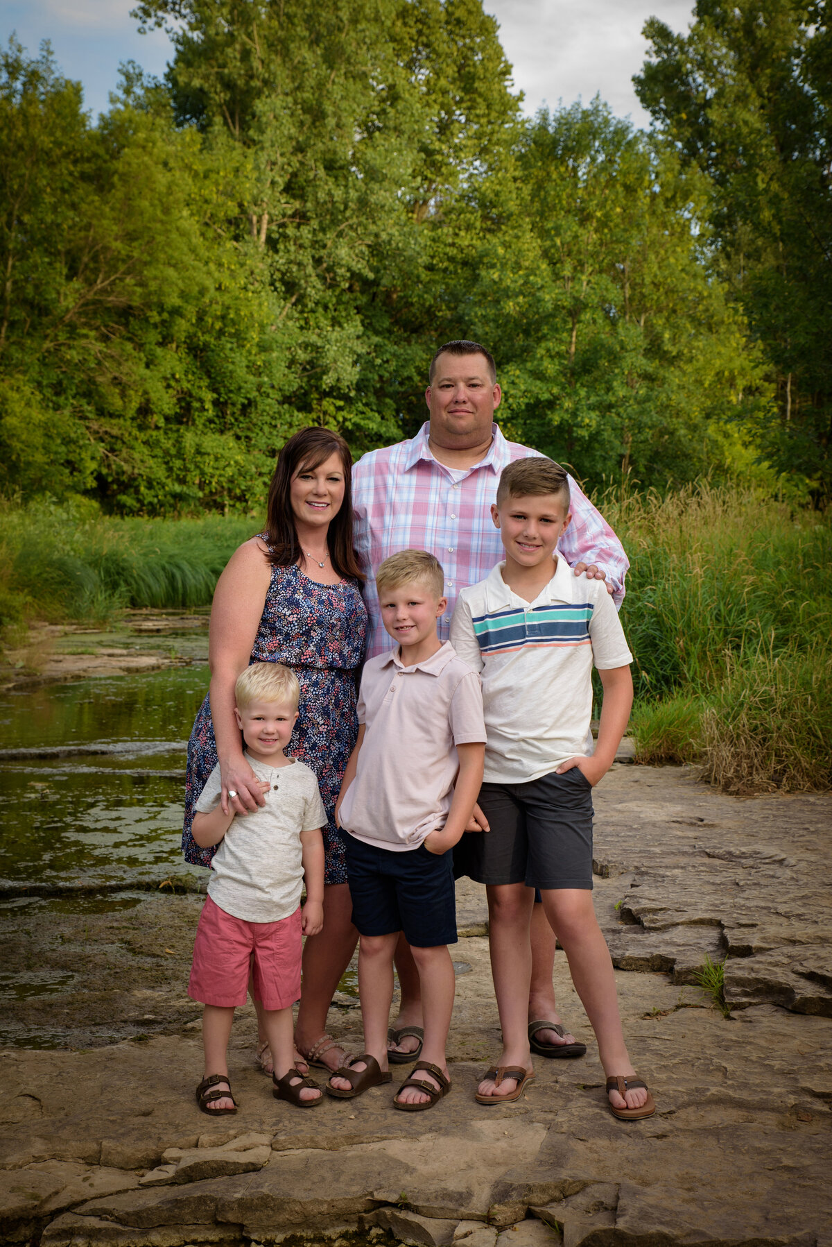 Family of five portrait with three boys standing near creek at Fonferek Glen County Park near Green Bay, Wisconsin