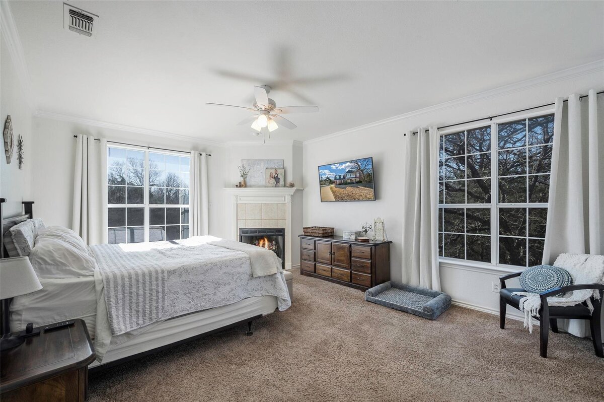 Master bedroom with fireplace in home for sale in Collinsville, Tx