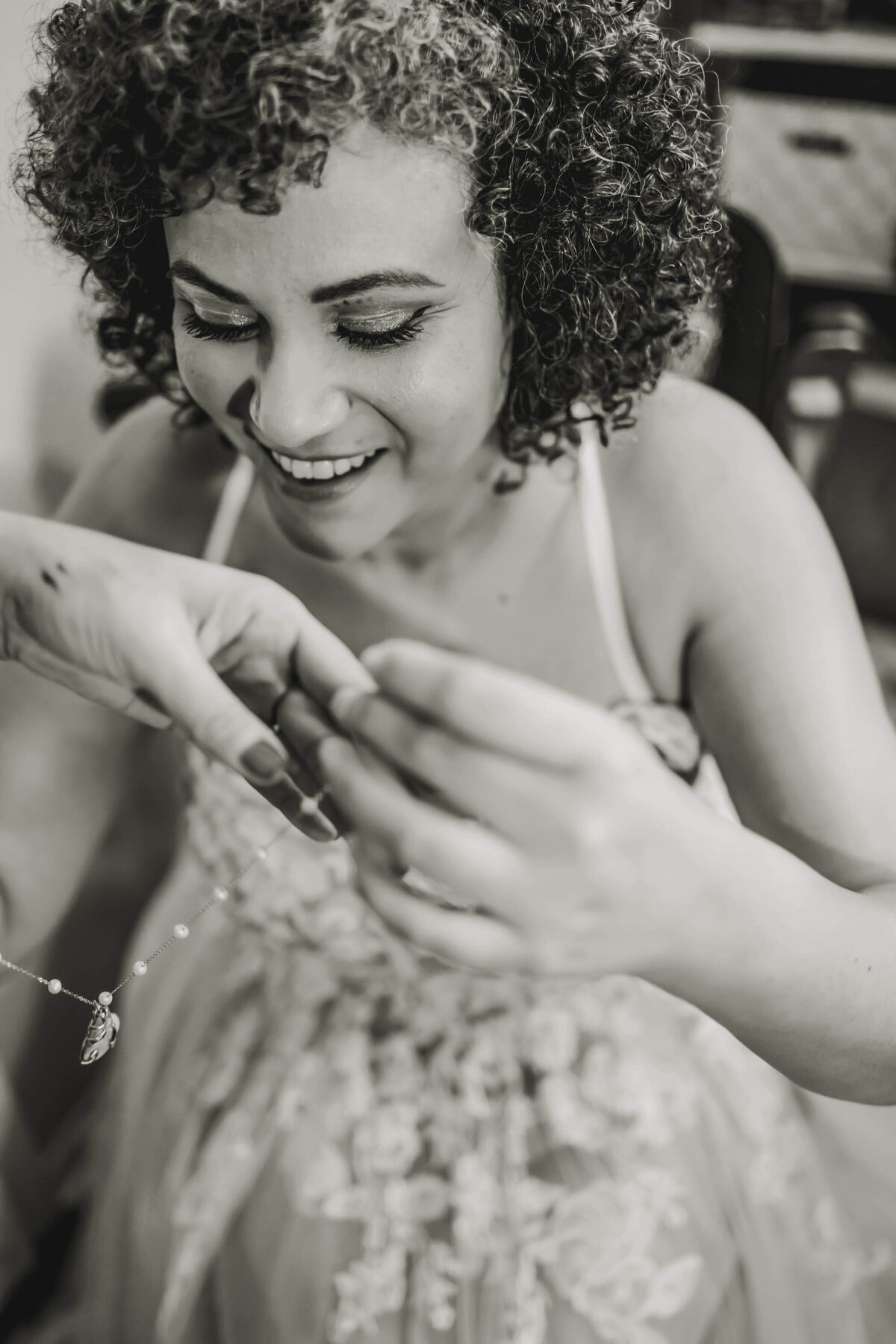 a dallas texas bride puts on her necklace for the wedding