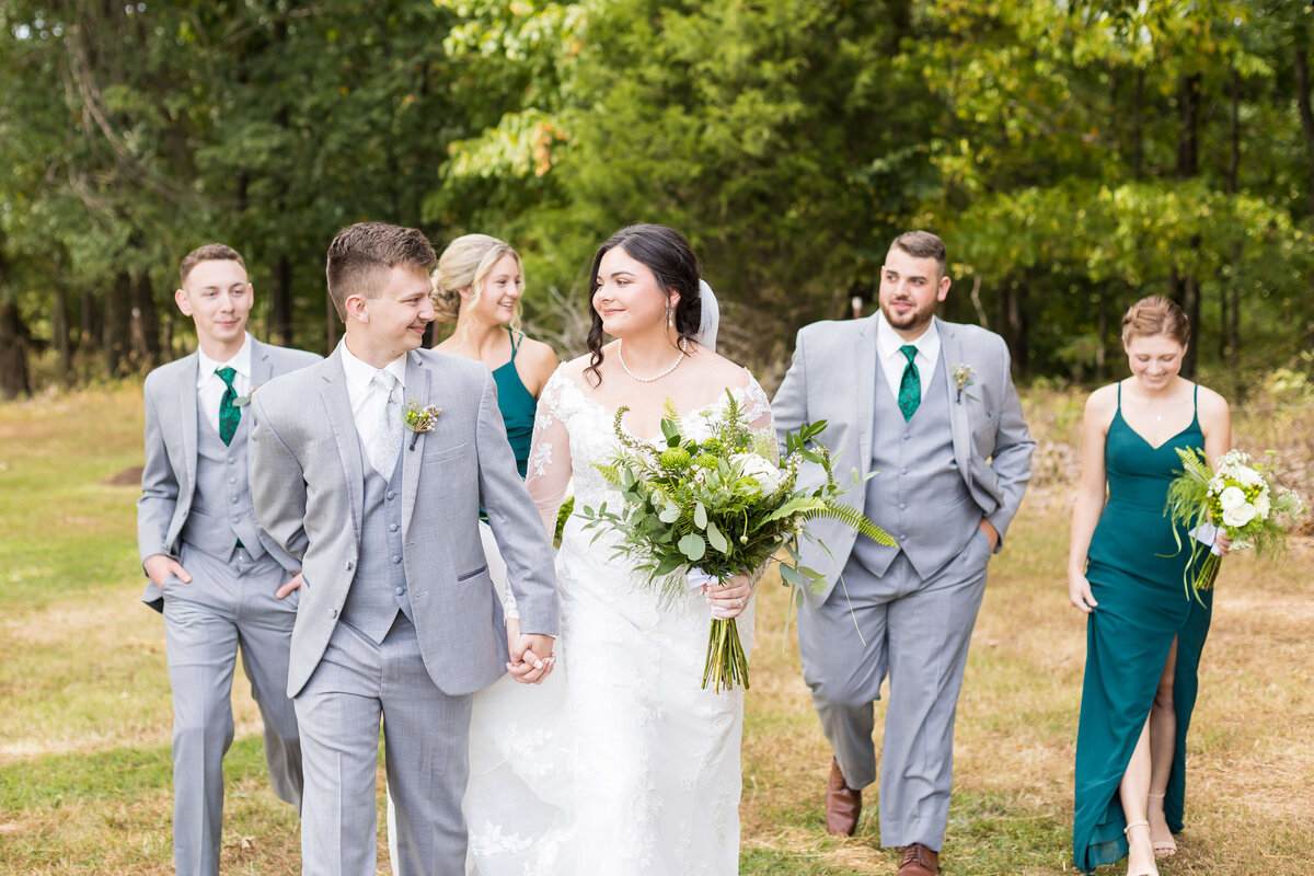 Bride and groom walking along with wedding party at wedding at Mahr Park, Tennessee